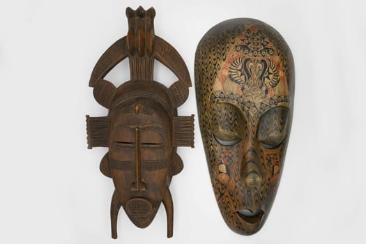 Brown wooden mask isolated on a white background Copy space