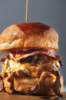 Double steak burger with smoked bacon, cheddar cheese and bbq sauce. High quality photo