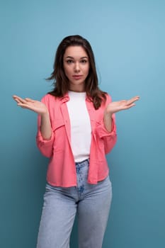 bright stylish brunette young woman in a fashionable shirt, t-shirt and jeans.