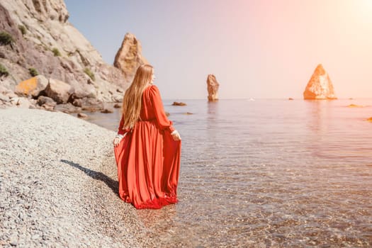 Woman travel sea. Happy tourist taking picture outdoors for memories. Woman traveler looks at the edge of the cliff on the sea bay of mountains, sharing travel adventure journey.