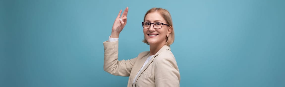 wide horizontal photo of a confident mature business lady in a classic jacket on a bright background with copy space.