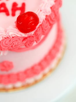 frosted pink red cake for mothers day celebration with funny text topping best mom evah on white studio background