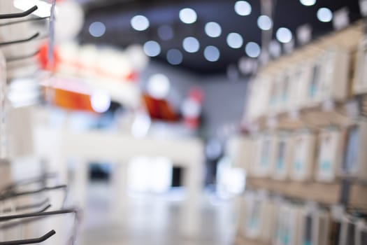 Blurred background from small electronics store and cellular accessories.
