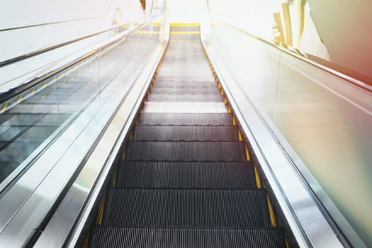 Moving stairway on escalator in interior of a public place.