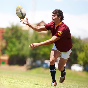 Man, game and rugby on field for competition by running for fitness or exercise with energy. Male athlete, ball and workout on grass for training with development or growth in sports in the outdoors