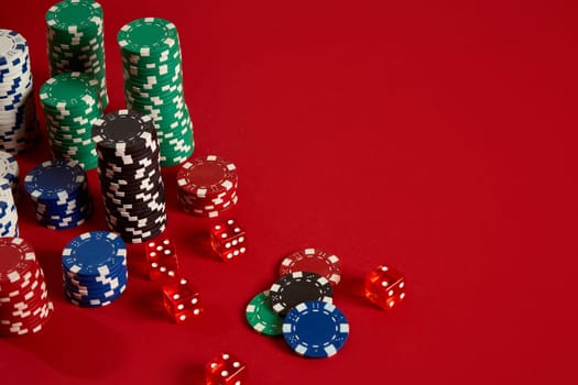 Poker chips on red background. Group of different poker chips. Casino background. Copy space. Still life