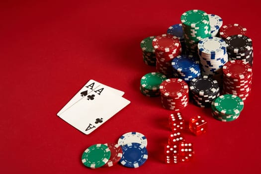 Poker chips and aces on red background. Group of different poker chips. Casino background. Copy space. Still life. One Pair