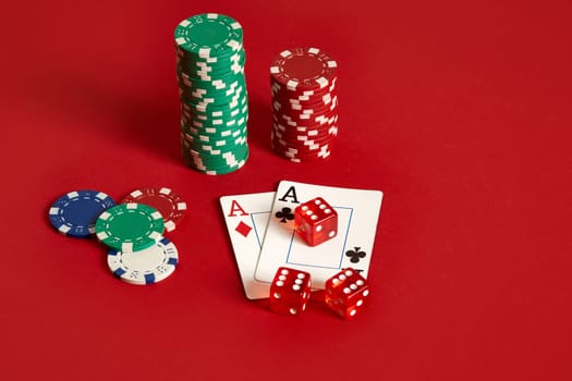 Poker chips and aces on red background. Group of different poker chips. Casino background. Copy space. Still life. One Pair