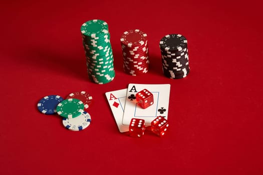 Poker chips and aces on red background. Group of different poker chips. Casino background. Copy space. Still life. One Pair