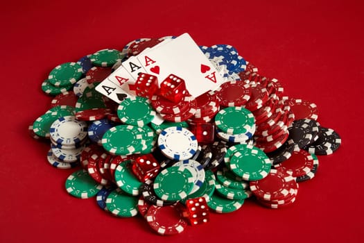 Poker cards and gambling chips on red background. Top view. Copy space. Still life. Flat lay. Cards - four aces. 4 of a kind