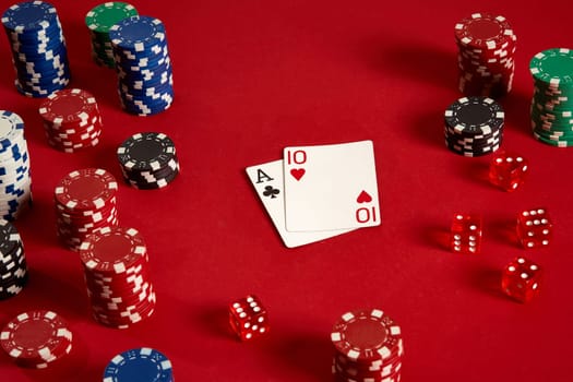 Poker cards and gambling chips on red background. Top view. Copy space. Still life. Flat lay. Cards - Ace and Ten