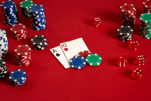 Poker cards and gambling chips on red background. Top view. Copy space. Still life. Flat lay. Cards - Ace and Ten