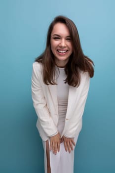 portrait of a cheerful well-groomed long-haired brunette woman in a white dress.