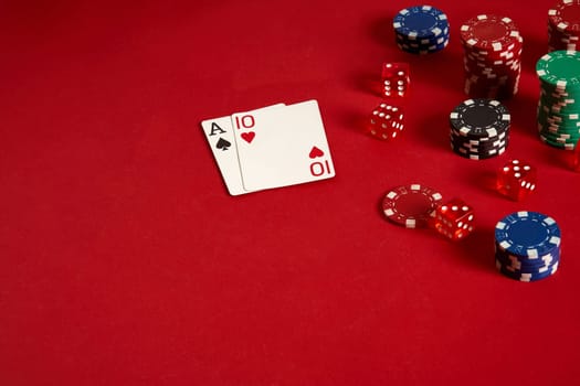 Poker cards and gambling chips on red background. Top view. Copy space. Still life. Flat lay. Cards - Ace and Ten
