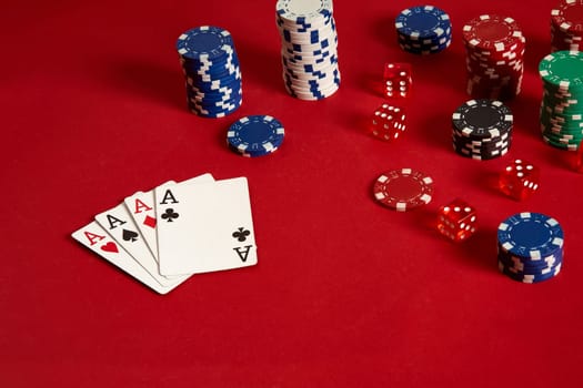 Poker cards and gambling chips on red background. Top view. Copy space. Still life. Flat lay. Cards - four aces. 4 of a kind