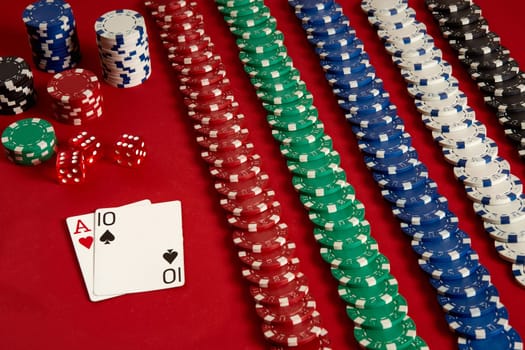 Poker cards and gambling chips on red background. Top view. Copy space. Still life. Flat lay. Cards - Ace and Ten