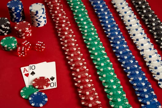 Poker cards and gambling chips on red background. Top view. Copy space. Still life. Flat lay. Cards - Ace and Ten