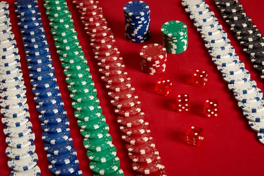 Stack of poker chips on red background at casino. Top view. Copy space. Still life. Flat lay