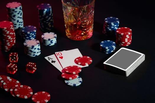 Cards of poker player. On the table are chips and a glass of cocktail with whiskey. Still life. The concept of gambling. Poker Online. Combination of cards