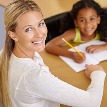 Private tutor, portrait and child to learn in class at desk at school for an education with support. Woman, teaching and writing student with smile for learning or reading in the classroom for study