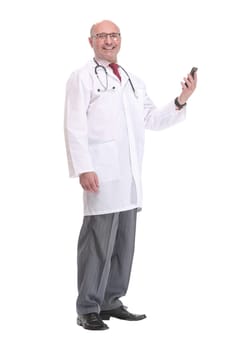 Portrait of happy senior smiling doctor holding smartphone. White isolated background.