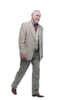 in full growth. confident old man striding forward . isolated on a white background.