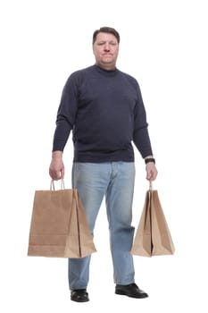 in full growth. Mature man in jeans striding forward.isolated on a white background.