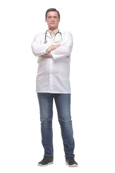 Serious male doctor in scrubs with a stethoscope around his neck and his arms crossed isolated on white background