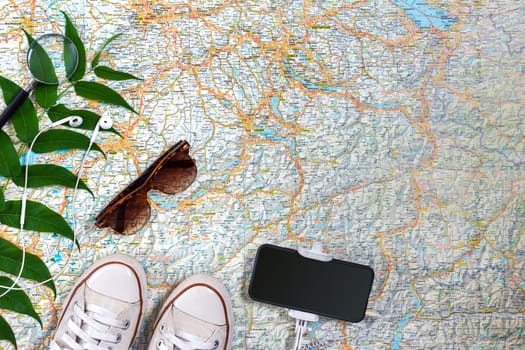 Travel plan, trip vacation accessories for trip, tourism mockup - Outfit of traveler on map background. Flat lay and copyspace. Still life