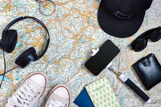 Travel plan, trip vacation accessories for trip, tourism mockup - Outfit of traveler on map background. Flat lay and copyspace. Still life