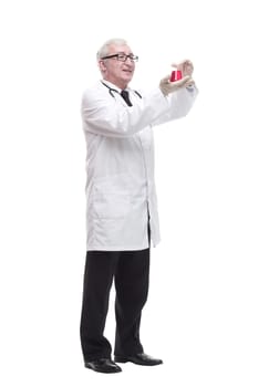 full-length. mature doctor with a laboratory flask in his hands . isolated on a white background.