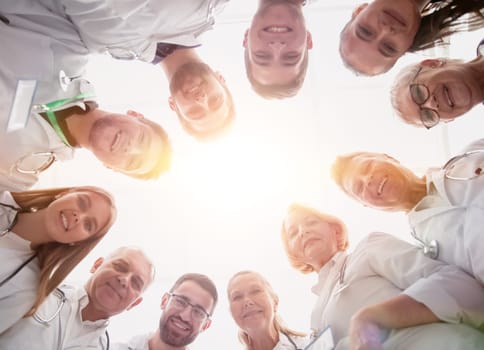 close up. group of doctors standing in a circle and looking at you . photo with a copy-space