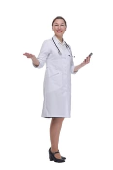 in full growth.female doctor with a smartphone. isolated on a white background.