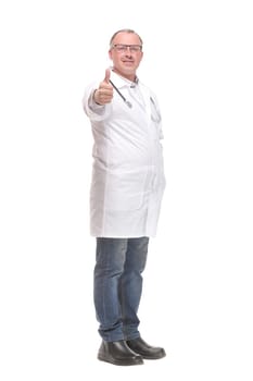 Cheerful mature doctor looking at camera and pointing away while standing against white background