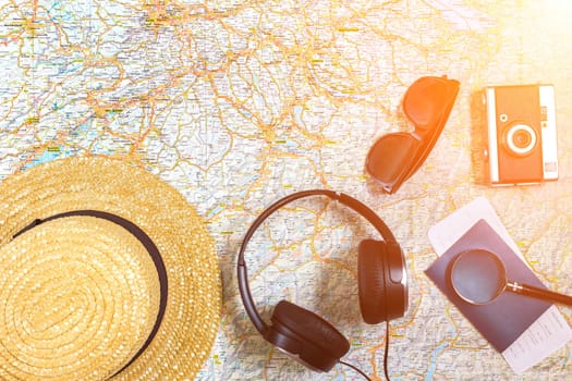 Travel plan, trip vacation accessories for trip, tourism mockup - Outfit of traveler on map background. Flat lay and copyspace. Still life. Sun flare