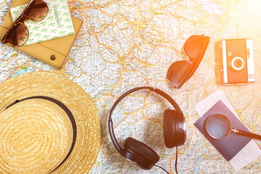 Travel plan, trip vacation accessories for trip, tourism mockup - Outfit of traveler on map background. Flat lay and copyspace. Still life. Sun flare