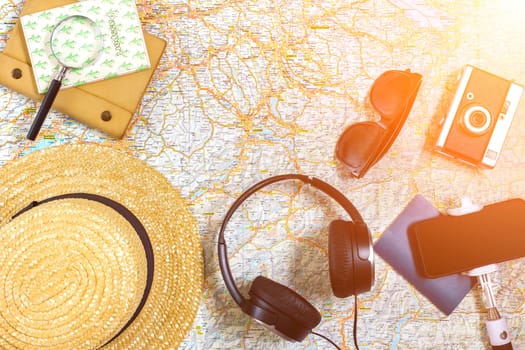 Travel plan, trip vacation accessories for trip, tourism mockup - Outfit of traveler on map background. Flat lay and copyspace. Still life. Sun flare