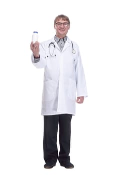 in full growth.smiling doctor showing a bottle of antiseptic. isolated on a white background.