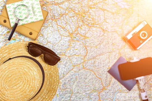 Travel plan, trip vacation accessories for trip, tourism mockup - Outfit of traveler on map background. Flat lay and copyspace. Still life. Sun flare