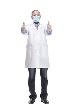 Full lenth of a doctor in uniform, on a white background pulls a glove on his arm. Concept of midical help