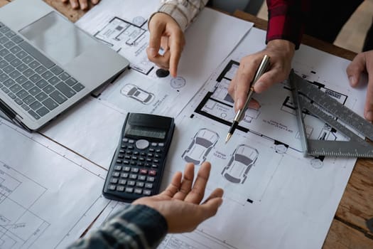 engineer people meeting working and pointing at a blueprint in office for discussing. Engineering tools and construction concept.