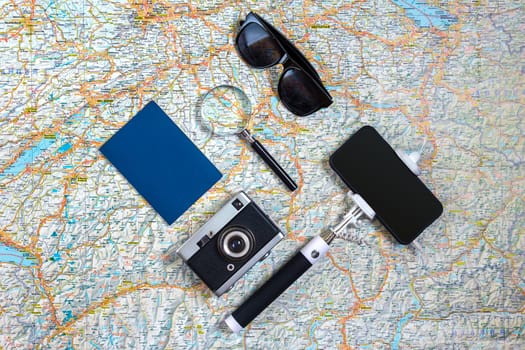 Travel accessories set on white background: smart, passport, map, camera and sunglasses. Top view point. Flat lay. Still life. Copy spase