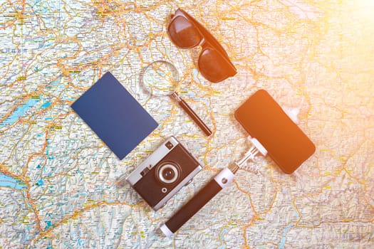 Travel plan, trip vacation accessories for trip, tourism mockup - Outfit of traveler on map background. Flat lay and copyspace. Still life. Sun flare