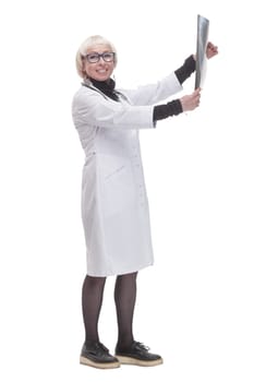 in full growth. female doctor with an x-ray. isolated on a white background.