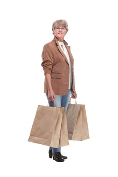 Full length portrait of a Senior woman walking with shopping bags and smilimg