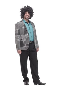 in full growth. cheerful man in a curly wig. isolated on a white background.