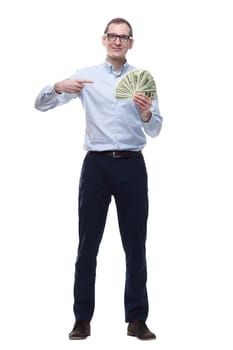 in full growth. happy man pointing to a fan of banknotes. isolated on a white background