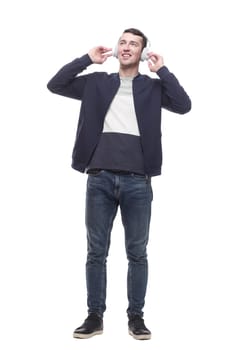 young man listening to music through headphones. isolated on a white background.