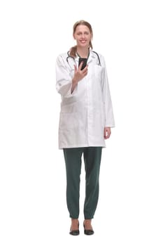 Front view of concentrated beautiful female doctor reading text message over white background