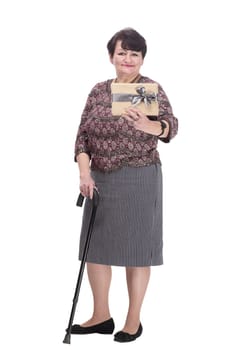 in full growth. elderly woman with a gift box. isolated on a white background.